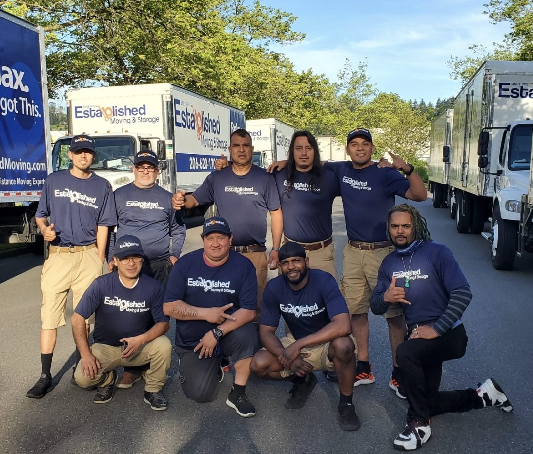 an established moving & storage crew celebrates a successful move